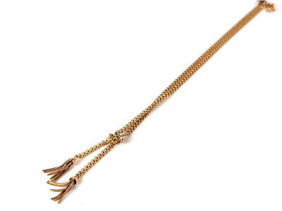 a close up of a gold chain bracelet with a tassel