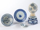 several blue and white plates and bowls on a white surface