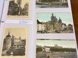 four old postcards of different buildings on a table