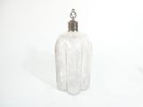 a clear glass bottle with a silver lid on a white surface