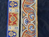 a close up of a blue and orange scarf with a design on it