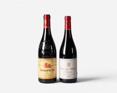 two bottles of wine sitting next to each other on a white surface
