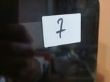 a person taking a picture of a number on a tablet