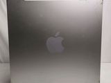a silver apple computer sitting on a white surface