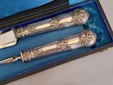 two silverware items in a blue box on a table