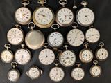 many different types of pocket watches displayed on a table