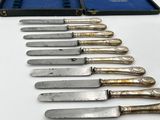 several knives are lined up in a row on a white surface