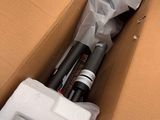 a cardboard box with a camera and some other items in it