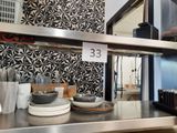 stainless steel counter top with dishes and utensils on it