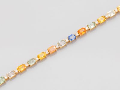 a close up of a bracelet with multi colored stones on it