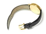 the watch is black and gold with a black leather strap