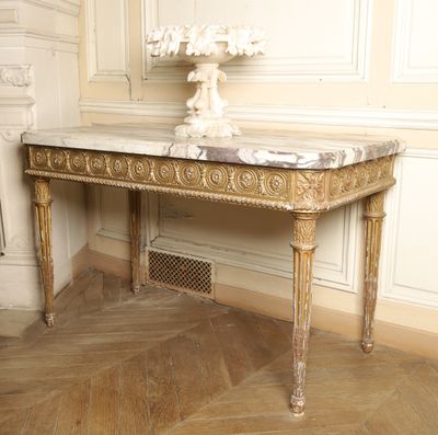 a marble table with a vase on top of it