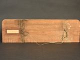 an image of a piece of wood with a string attached to it