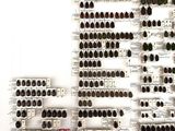 a wall of wine bottles on the shelves in the room