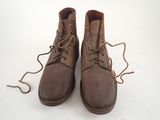 pair of brown leather boots with laces on a white surface