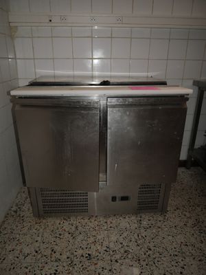 two stainless steel ovens in a kitchen with a tile floor