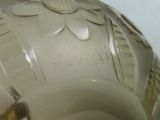a white vase with a flower design on it