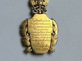 an image of a gold plated pendant with a coat of arms on it