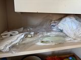 a picture of a cluttered kitchen cupboard with a lot of clutter