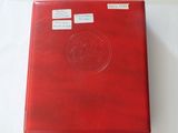 a red folder with stickers on it sitting on a table