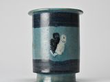 a blue and black vase with a heart on it