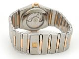 a watch that is on a bracelet on a white surface