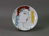 an image of a plate with a woman ' s face painted on it