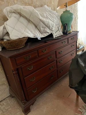 a bed and a dresser in a room with a large window