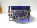 a blue glass bowl sitting on top of a white table