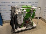 an image of a green machine sitting on top of a cart in a room