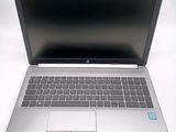 an open laptop computer sitting on top of a white table
