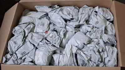 a cardboard box filled with a lot of crumpled clothes