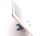a tablet computer sitting on top of a wooden stand