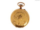 a gold pocket watch with a picture of a woman on it