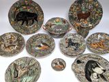 a group of plates with animals on them sitting on a table