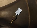 a car key sitting on the seat of a brown leather chair