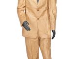 a mannequin dressed in a tan suit and black shoes