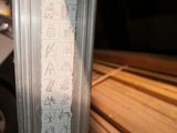 a close up of a piece of wood with writing on it