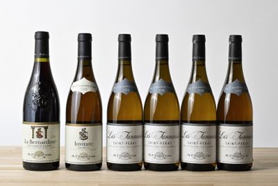 six bottles of wine are lined up on a wooden table