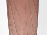 a pink glass vase sitting on top of a table
