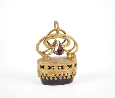 an image of a gold crown with a pink stone in it