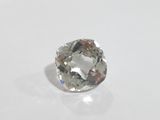 a close up of a white diamond on a white surface