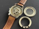 a watch that is sitting on a table next to a ring