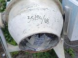 a cement mixer sitting on the side of the road