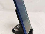 a close up of a cell phone on a stand on a white surface