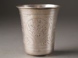 a silver cup that has a design on the inside of it