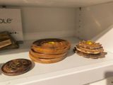 a shelf that has a bunch of wooden objects on it