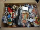 a cardboard box filled with many different types of dolls