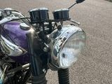 a purple motorcycle that is parked in a parking lot