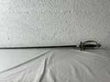 a sword that is laying on a bed with a white sheet